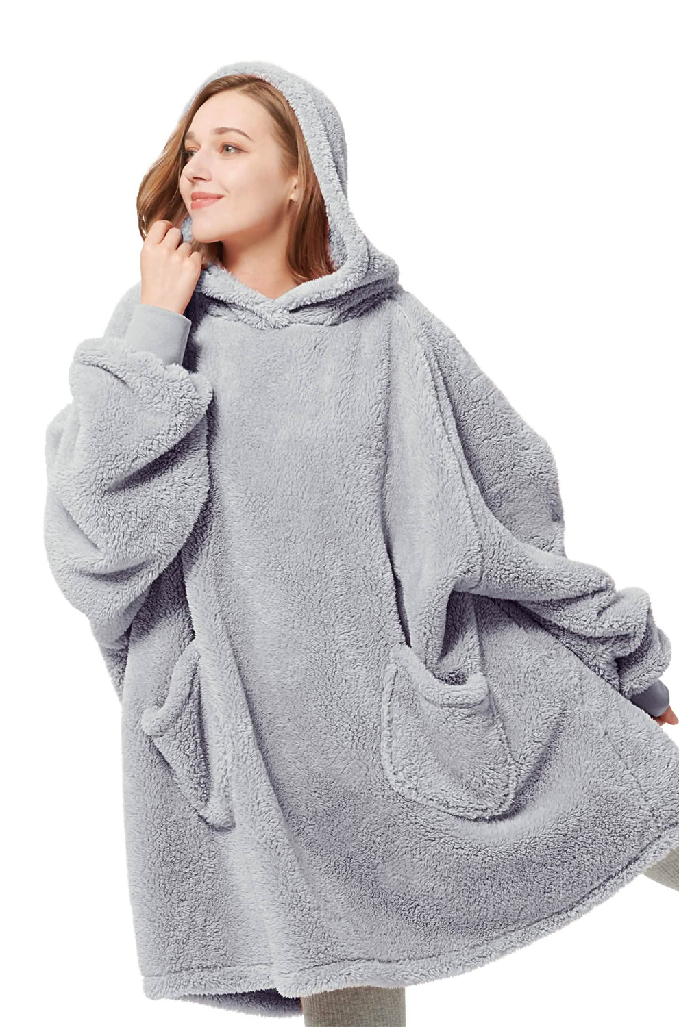 Person wearing a gray fleece poncho with hood on a white background