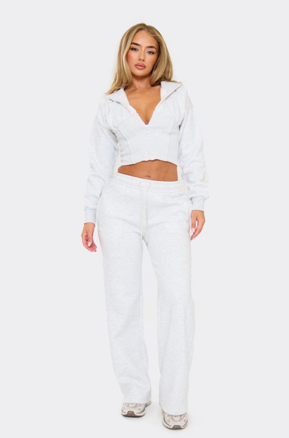 Woman wearing a white outfit on a white background