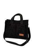 Black tote bag with a brown patch on a white background